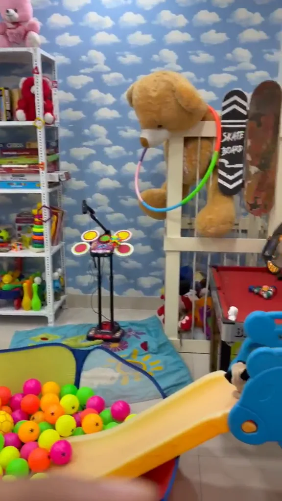 Ball pit with a slide, skateboards, a mini pool table and karaoke stand